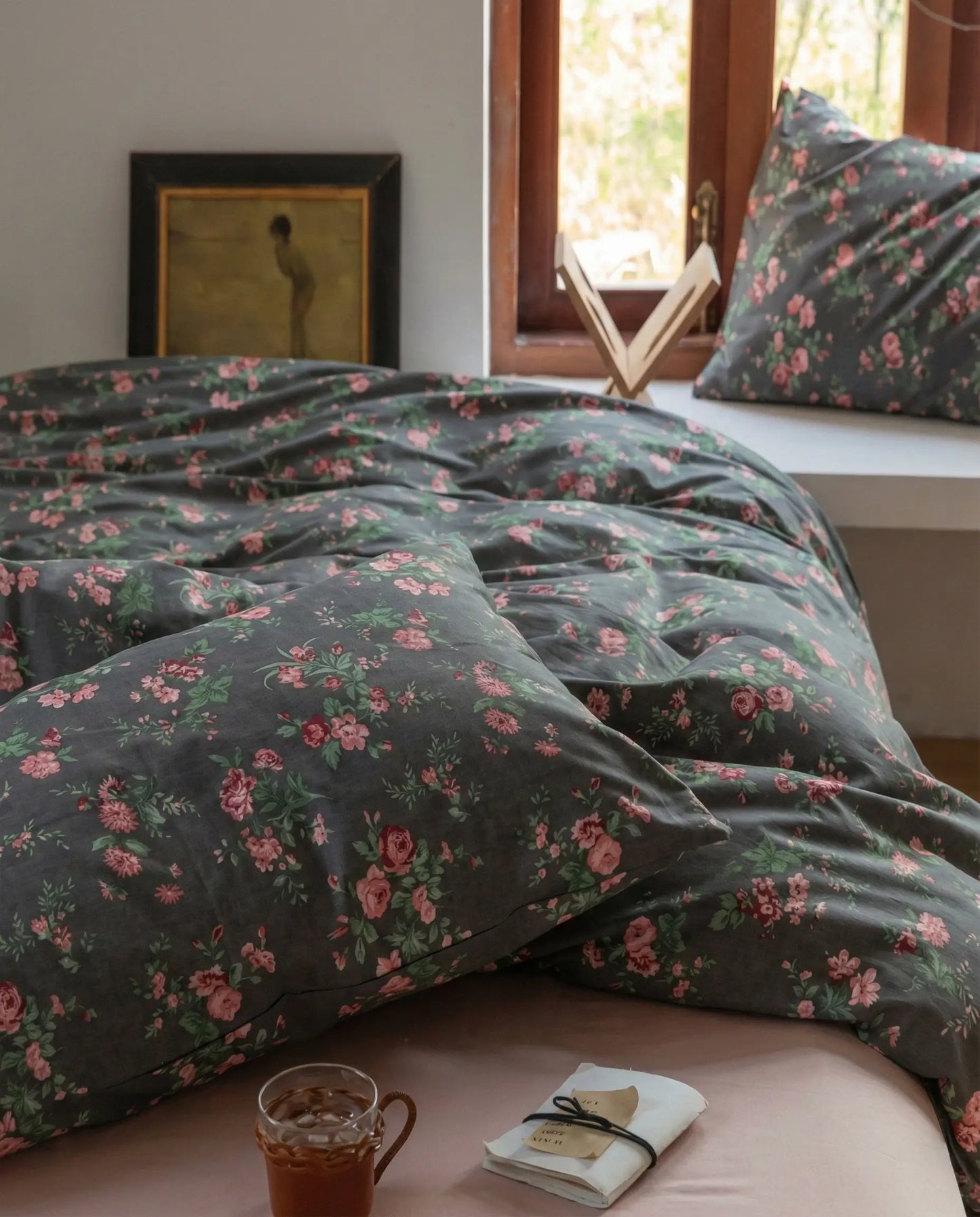 Black floral bedding set in natural light bedroom with window, soft cotton duvet cover and matching pillowcases