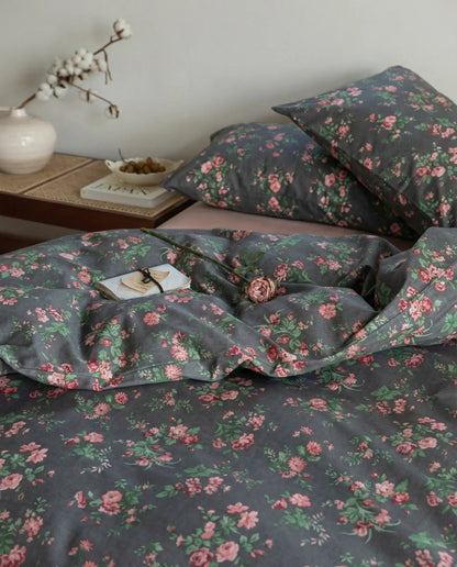 Close up of black floral cotton duvet cover with pink rose pattern, soft luxury bedding texture and styling