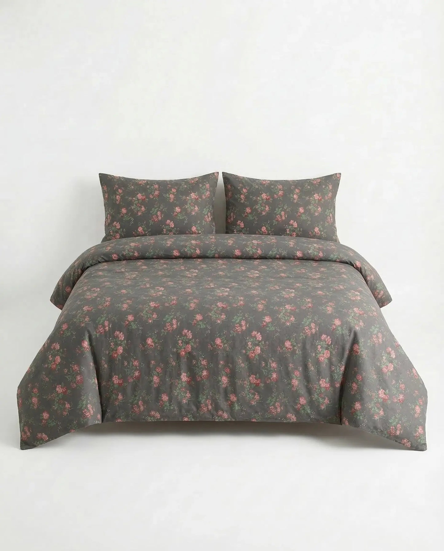 Black floral duvet cover set on full bed with matching pillowcases, elegant dark botanical cotton bedding