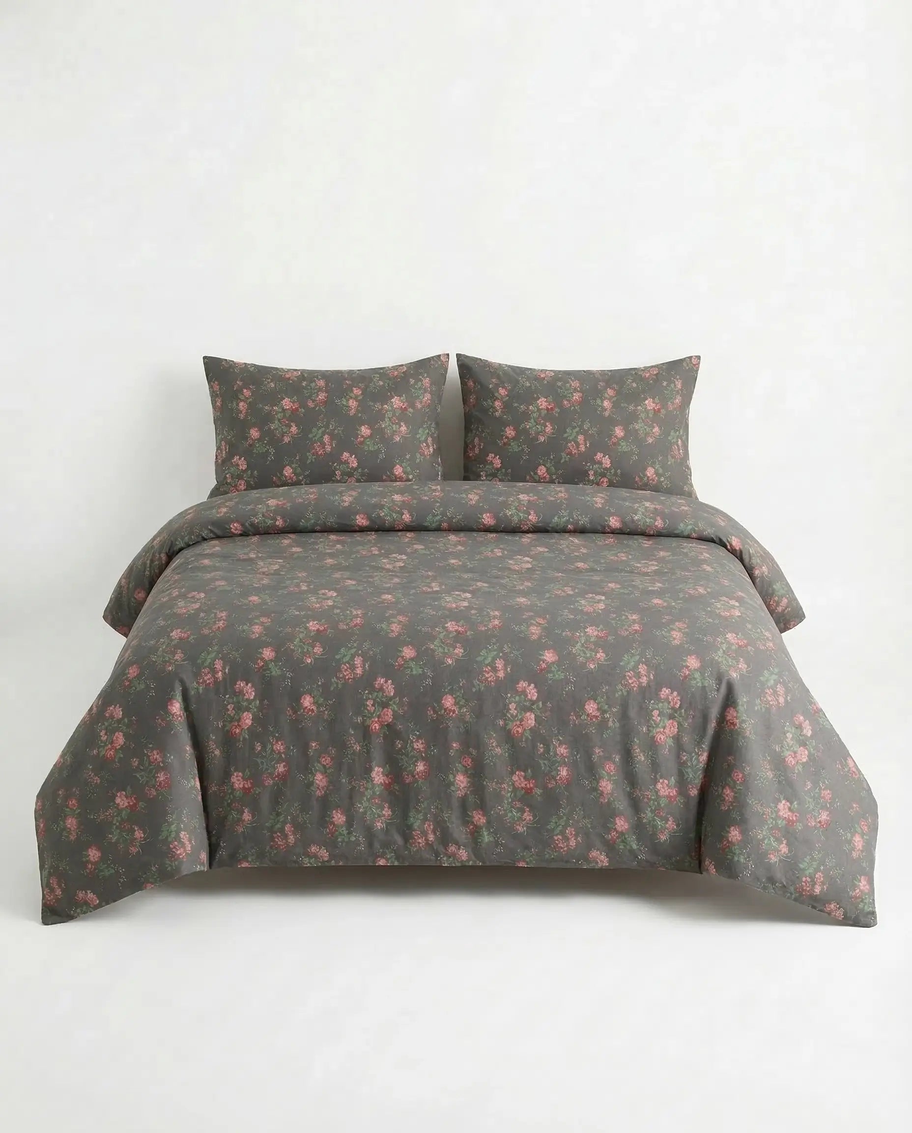 Black floral duvet cover set on full bed with matching pillowcases, elegant dark botanical cotton bedding