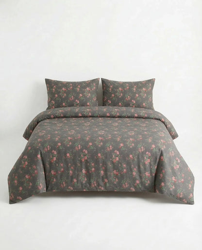 Black floral duvet cover set on full bed with matching pillowcases, elegant dark botanical cotton bedding