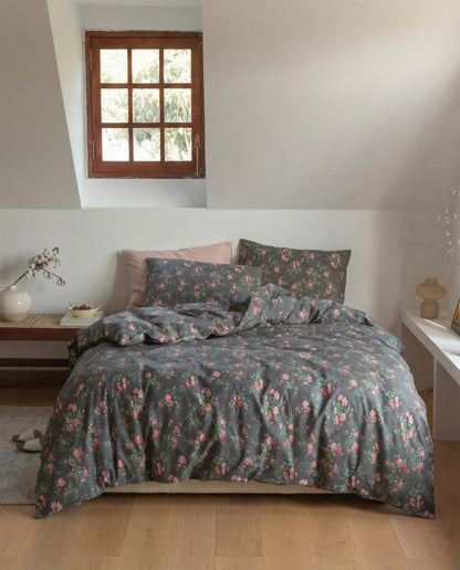 Black floral duvet cover set styled in cozy bedroom with wooden floor and neutral decor, elegant cotton bedding