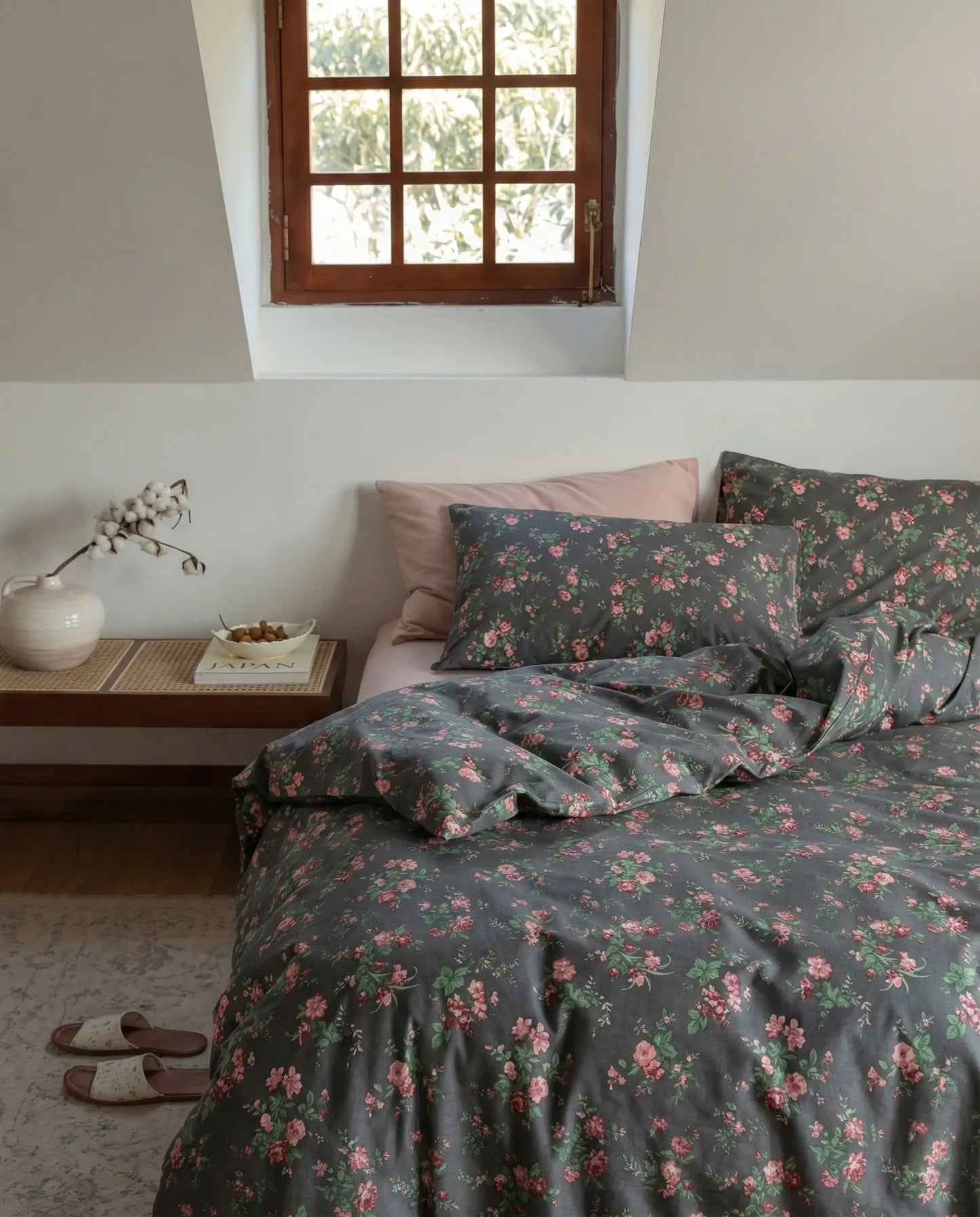 Black floral duvet cover set styled on bed with pink pillows and wooden nightstand, modern romantic bedroom decor