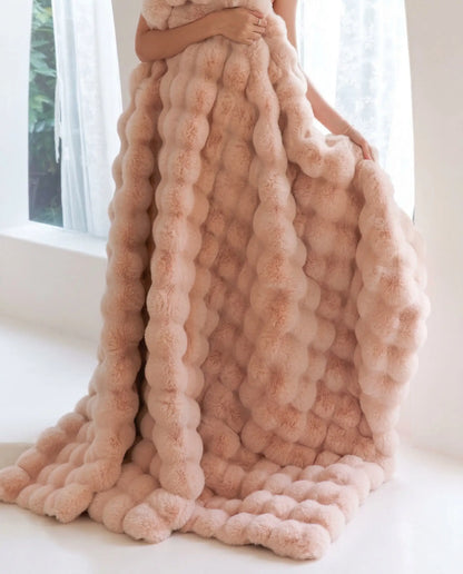 DORMÉ Studio Marshmallow Ultra Plush Blanket pink plush fabric draped vertically showing sculpted cloud like texture.