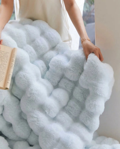 Close up of DORMÉ Studio Marshmallow Ultra Plush Blanket blue plush texture showing thick sculpted cloud like fabric.