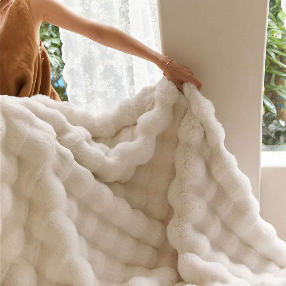 VibeCore Marshmallow Ultra Plush Blanket White Plush Texture Close Up, being held up by a woman and demonstrating the plush, luxurious blanket.