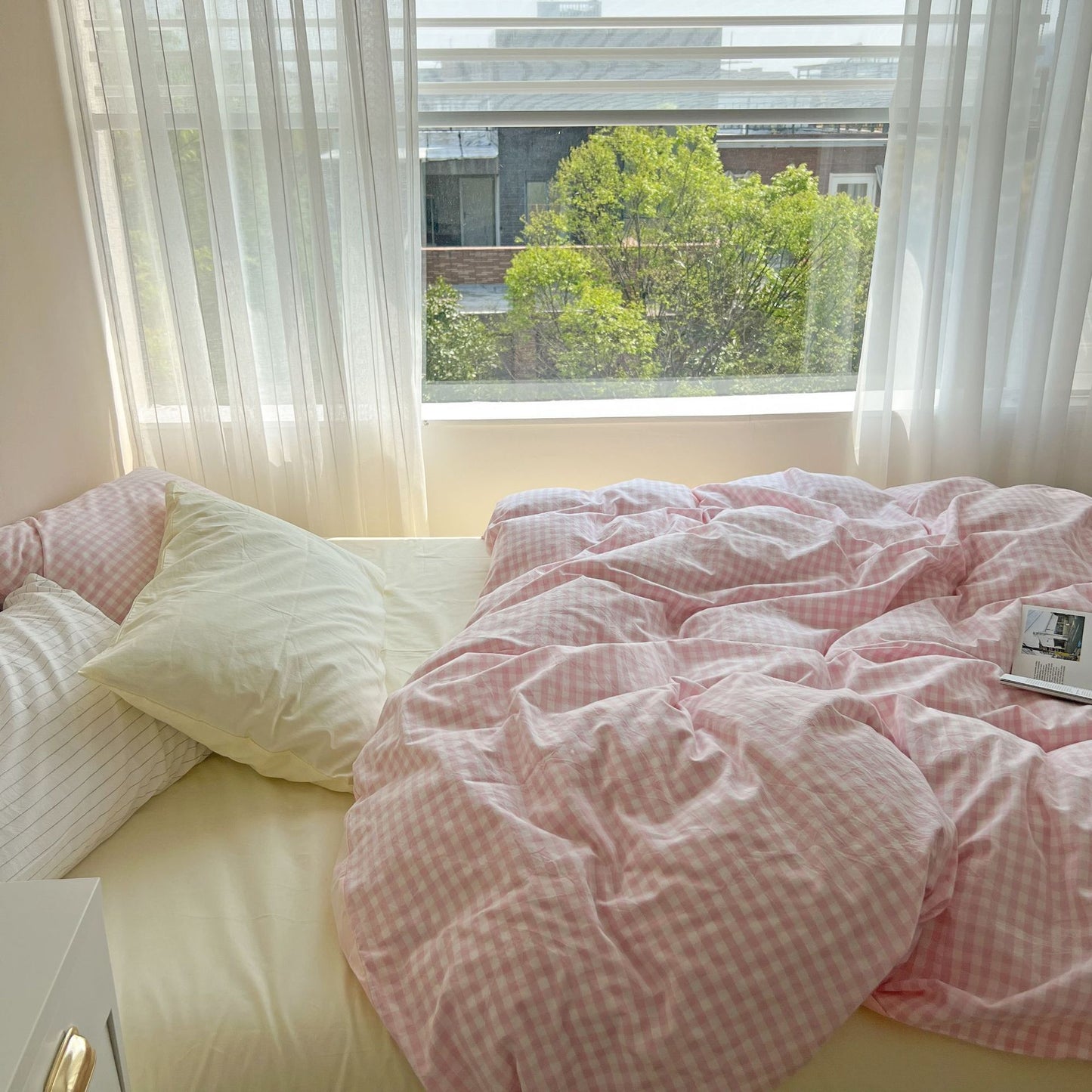 Side view of the VibeCore Pastel Pink Plaid Bedding Set, highlighting its gentle pastel plaid pattern and soft, cozy texture that adds a touch of warmth and charm to any space.