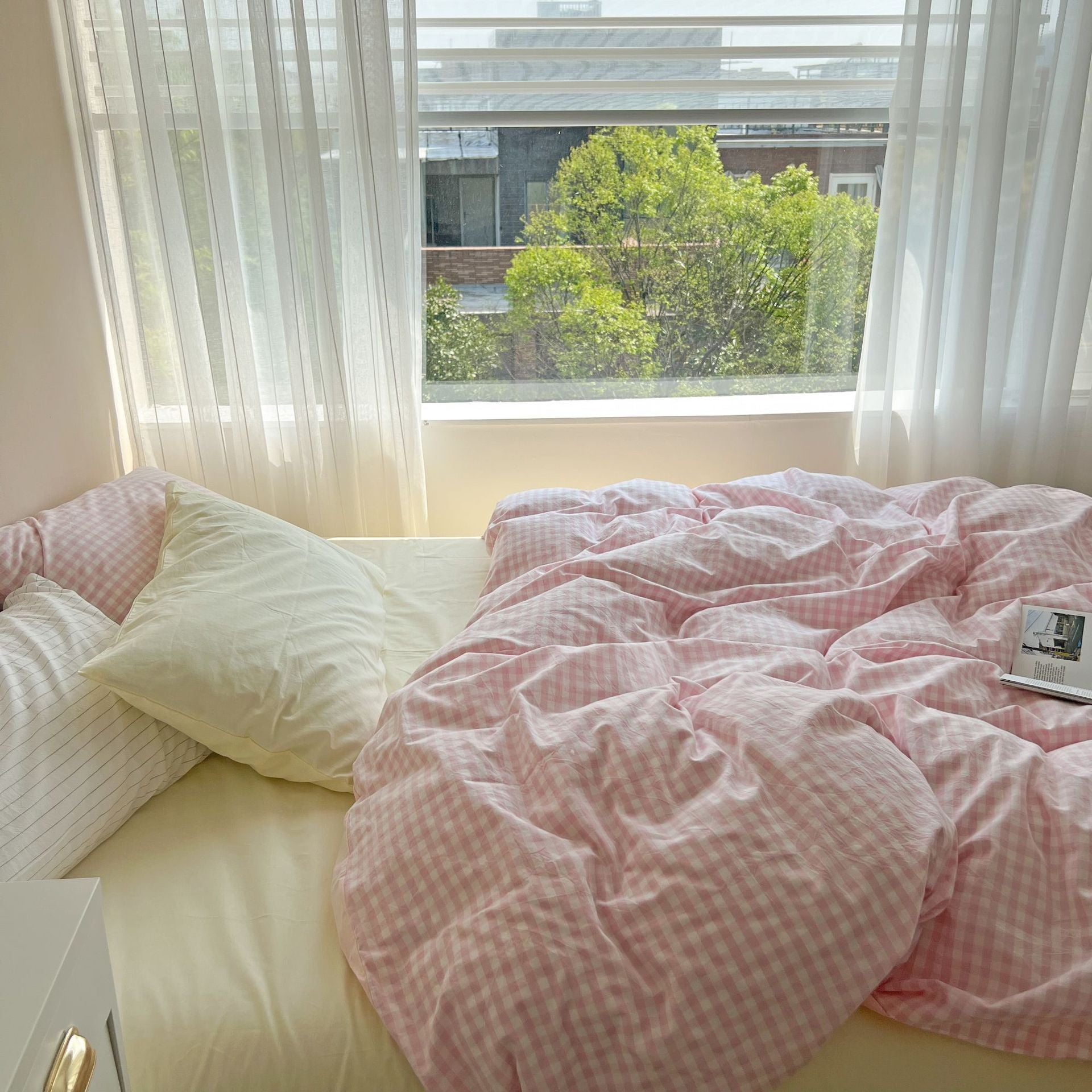 Side view of the VibeCore Pastel Pink Plaid Bedding Set, highlighting its gentle pastel plaid pattern and soft, cozy texture that adds a touch of warmth and charm to any space.