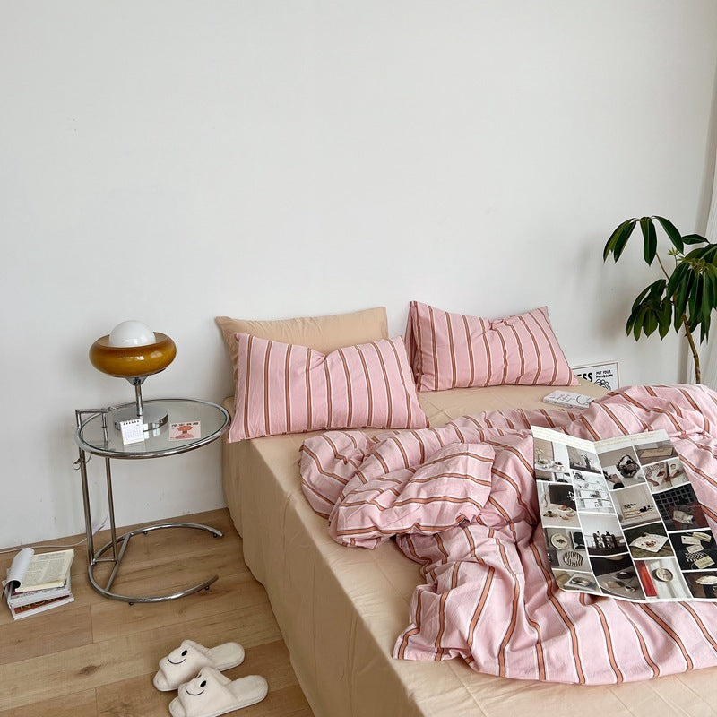 Aerial side view of the VibeCore Pink Stripe Bedding Set, made from 100% cotton, showcasing its soft fabric and stylish pink striped pattern. The modern, calming aesthetic adds a luxurious, comfortable touch to your bedroom or dorm decor, perfect for creating a cozy and elegant space.
