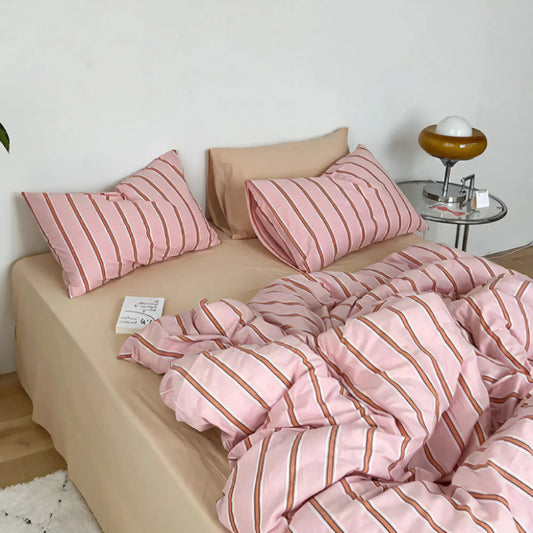 Close-up side view of the VibeCore Pink Striped Bedding Set, made from 100% breathable cotton. Featuring a stylish pink stripe pattern, this bedding set combines cozy comfort with a modern aesthetic, perfect for adding a playful yet calming vibe to your bedroom or dorm decor. Ideal for those who want effortless style and comfort.