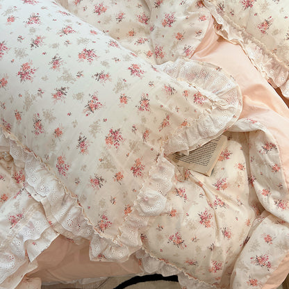 VibeCore Coquette Embroidered Pink Floral Duvet Cover Set pillowcase close-up, showcasing delicate pink floral embroidery and soft cotton fabric for a cozy, feminine touch.