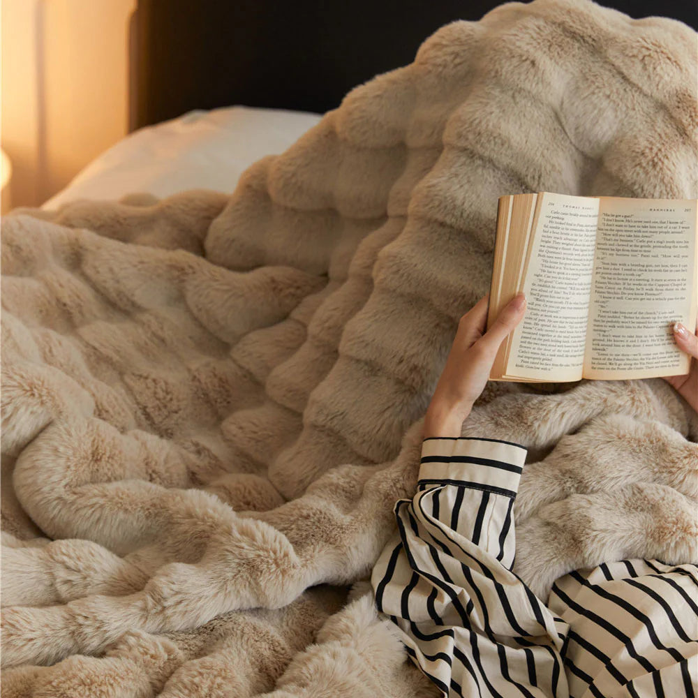 VibeCore Marshmallow Ultra Plush Blanket Khaki Close Up Of Woman Snuggled In It On Bed, showing it's ultra plush and tufted material.