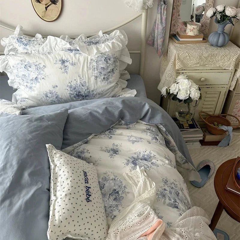 Bedroom with floral bedding and decorative pillows
