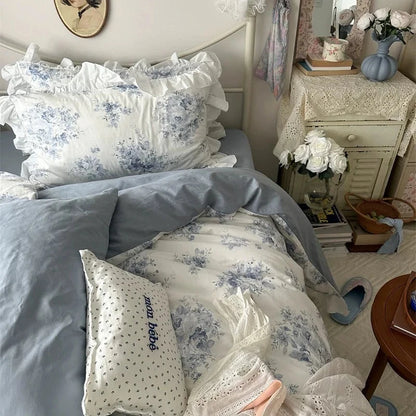 Bedroom with floral bedding and decorative pillows